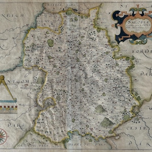 May include: Antique map of Salop, England, with detailed cartography. The map features intricate details, including towns, rivers, and geographical features. The map is framed by decorative borders and includes text in ornate lettering. The color palette includes shades of beige, green, and blue.