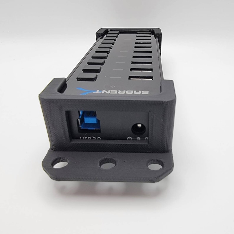 May include: A black USB hub with 12 ports and a power adapter. The hub is labeled "SABRENT".