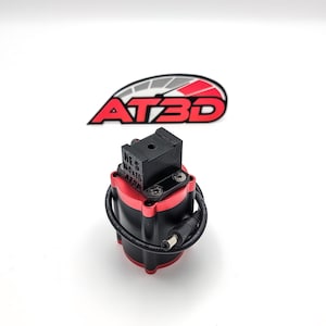 May include: A red and black flash unit with a black mounting bracket. The flash unit has a black cord attached to it.