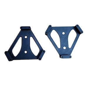 May include: Two black plastic triangular brackets with holes and rounded edges.