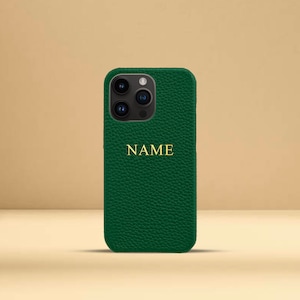 May include: A green leather phone case with a gold embossed name "NAME" on the back.