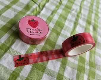 May include: Pink and red washi tape with a strawberry pattern. The tape is rolled up and the label reads "Strawberry Patch Washi" by "Peachikleen".