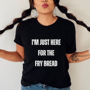 May include: A black t-shirt with the text "I'm just here for the fry bread" printed in white.