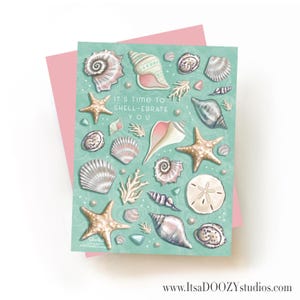 May include: A rectangular greeting card with a light teal background featuring various illustrations of seashells, starfish, and coral. The text in the center reads, IT'S TIME TO SHELL-EBRATE YOU. The card is positioned against a solid pink envelope.