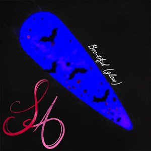 May include: A blue nail polish with black bats and pink glitter. The polish glows in the dark and the text "Boo-tiful (glow)" is written on the side.
