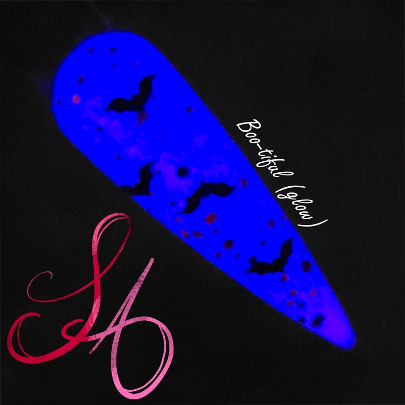 May include: A blue nail polish with black bats and pink glitter. The polish glows in the dark and the text "Boo-tiful (glow)" is written on the side.