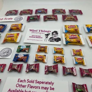 May include: A collection of miniature snack food bags, including Totino's Pizza Rolls, in 1:6 and 1:12 scale. The bags are arranged on a white surface with a business card for "Mini Things Boutique" in the center. The image includes the text "1:6 Scale", "1:12 Scale", "Each Sold Seperately", "Other Flavors may be Available but are not pictured."