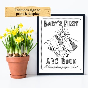 Op de afbeelding: Zwart-witte printbare poster voor het eerste ABC-boekje van een baby. De poster toont een berglandschap met een zon en de tekst "BABY'S FIRST ABC BOOK. Please take a page to color!"