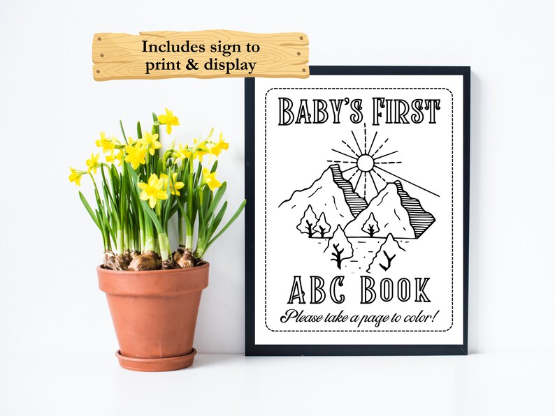 Op de afbeelding: Zwart-witte printbare poster voor het eerste ABC-boekje van een baby. De poster toont een berglandschap met een zon en de tekst "BABY'S FIRST ABC BOOK. Please take a page to color!"
