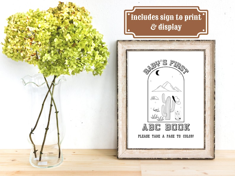 May include: A printable sign for a baby's first ABC book. The sign features a black and white illustration of a cactus in a desert landscape with a crescent moon and stars. The text reads "Baby's First ABC Book. Please take a page to color!"