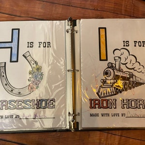 May include: A two-page spread from a children's alphabet book. The left page features the letter H in blue with a horseshoe illustration and the text "H is for Horseshoe". The right page features the letter I in yellow with an illustration of a train and the text "I is for Iron Horse".