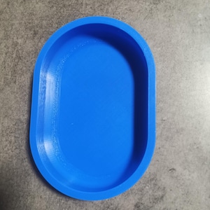 Könnte beinhalten: Eine hellblaue, ovale Schale aus Kunststoff. Die Schale ist glatt und hat einen leichten Rand.