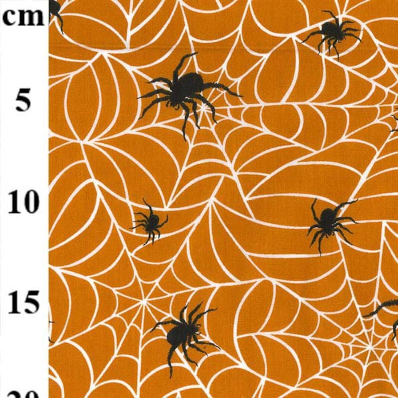 May include: Orange fabric with a white spiderweb pattern and black spiders. The spiders are in various sizes and positions, with some crawling on the web. The fabric is suitable for Halloween-themed crafts and decorations.