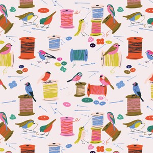 May include: A repeating pattern with illustrations of birds, thread spools, buttons, and needles. The design features a range of thread colours and bird species, creating a playful and artistic aesthetic. The background is a pale pink.
