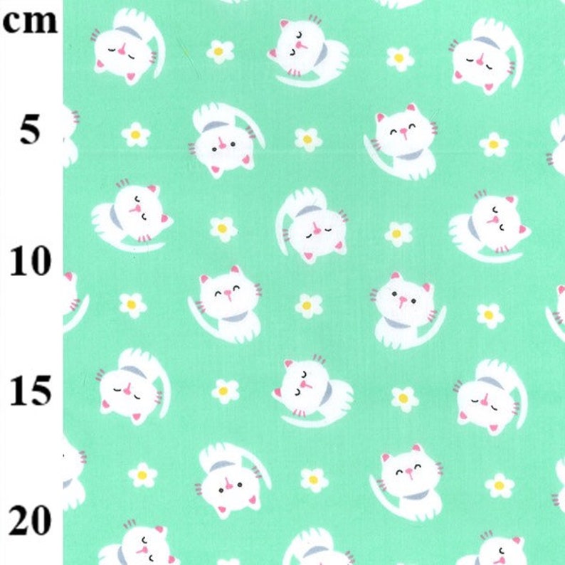 May include: A light green fabric with a repeating pattern of white cartoon cats and small white flowers. The cats are in various poses, with their tails curved. The fabric is measured in centimeters.