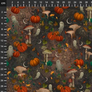 May include: A dark brown fabric featuring a repeating pattern of orange pumpkins, beige mushrooms, white ghosts, spider webs, crescent moons, and green leaves. A ruler along the top and left side shows the scale in centimetres.