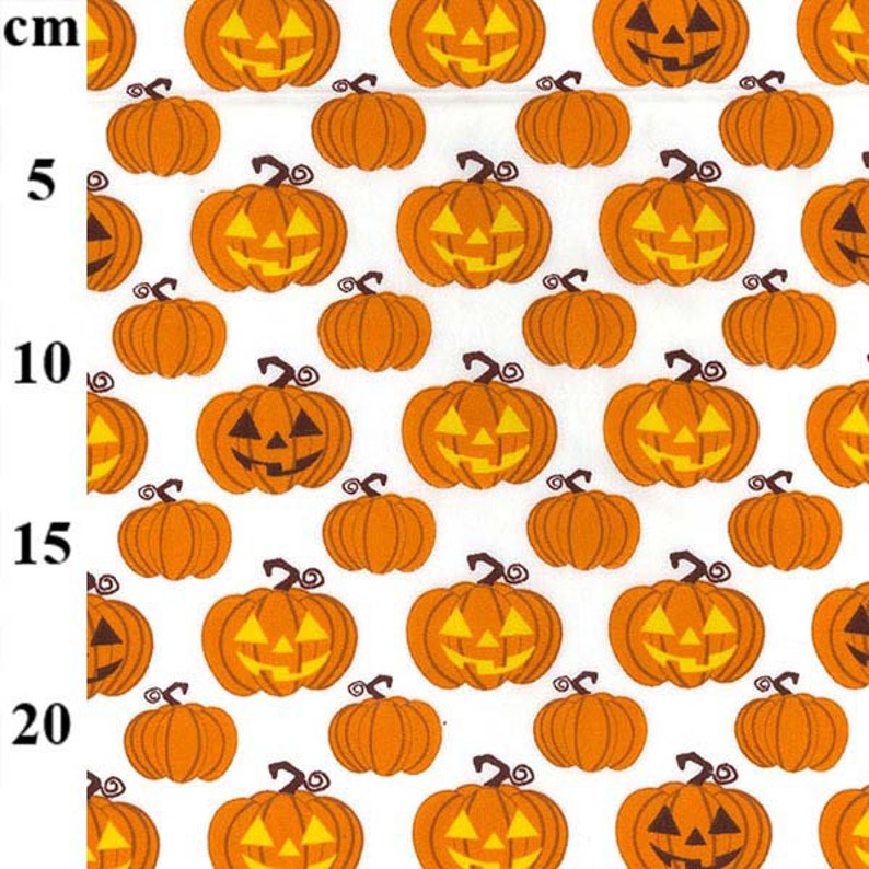 May include: A repeating pattern of orange jack-o'-lanterns with carved faces and curly stems on a white background. The pumpkins vary in size and are evenly spaced, creating a festive Halloween design. The pumpkins are approximately 2 inches in height.