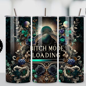 May include: A stainless steel tumbler with a floral and ornate design in teal, black, and gold. The text "BITCH MODE LOADING" is displayed prominently. The tumbler includes a straw and a lid.