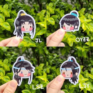 May include: Four stickers featuring cartoon characters with black hair, blue eyes, and red cheeks. Each sticker has a different character with a unique headband. The stickers are on a green background.