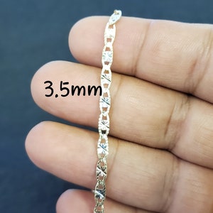 May include: A gold chain necklace with a 3.5mm width. The chain has a diamond-cut design.