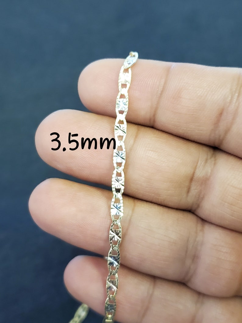 May include: A gold chain necklace with a 3.5mm width. The chain has a diamond-cut design.