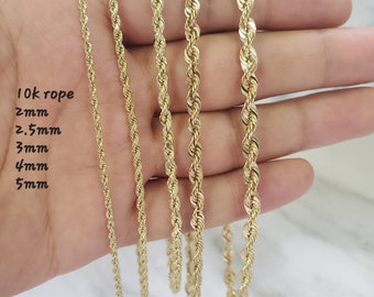 May include: Five gold rope chains of different thicknesses, labeled 2mm, 2.5mm, 3mm, 4mm, and 5mm. The chains are held in a hand against a white background. 10k rope.