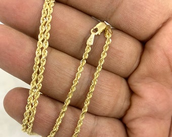 May include: A gold rope chain necklace. The chain is made of 14k gold and has a classic rope design.