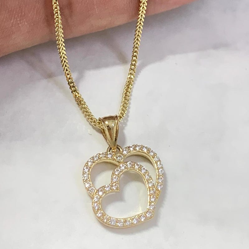 Heart of two intertwined white or yellow gold cz necklace.