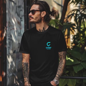 May include: Black t-shirt featuring a teal "C" logo and the words "CHIEF GAMING". The short-sleeved shirt is made of a lightweight material.