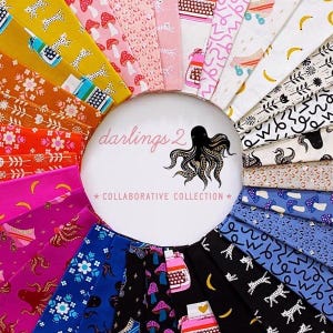May include: A collection of colorful fabric swatches arranged in a circular pattern. The fabrics feature various patterns, including mushrooms, typewriters, and abstract designs. A central white circle displays the text "darlings 2" and an octopus illustration.