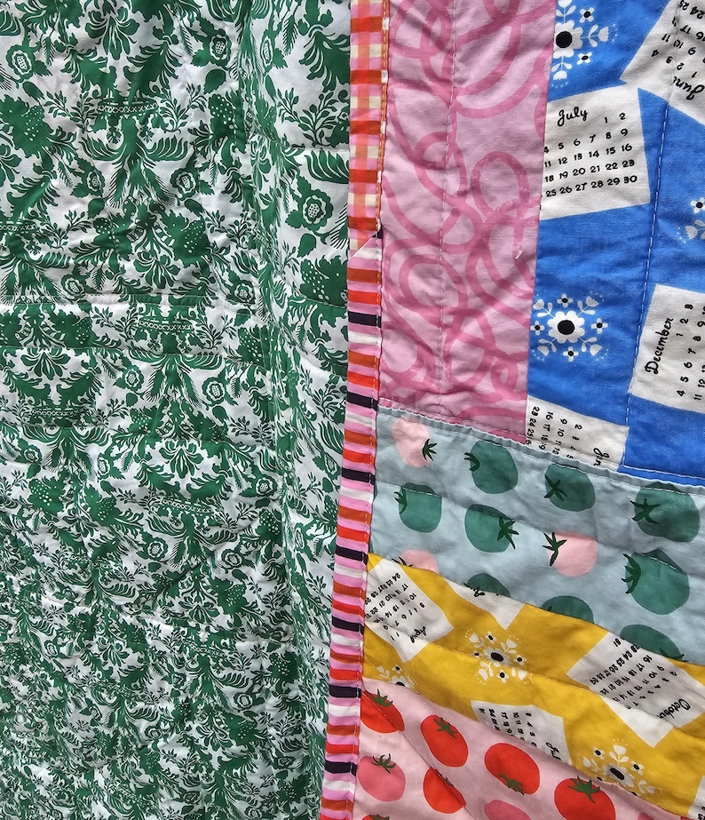 May include: A patchwork quilt with a variety of fabrics and patterns, including green floral, pink, blue, and yellow. The quilt features a calendar design with the months of June, July, and December.