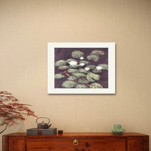 May include: A framed painting of white water lilies with green leaves on a dark background.