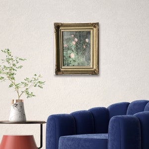 May include: A framed painting of pink flowers in a green bush. The frame is gold and has a decorative design.