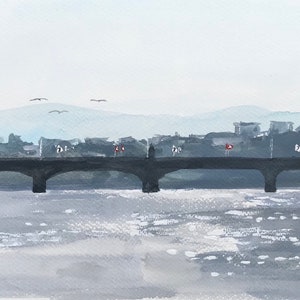 May include: A watercolor painting of a bridge over a river with a city skyline in the background. The sky is a light gray, and the water is a light blue. The bridge is a dark gray, and the city skyline is a light gray. There are a few birds flying in the sky.