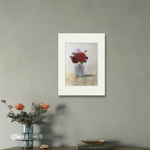 May include: A framed painting of a bouquet of red and purple flowers in a clear glass vase. The flowers are arranged in a simple, elegant way, and the painting is done in a realistic style.