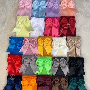 May include: A collection of 20 knee-high socks with large satin bows in various colours, including pink, blue, yellow, red, white, green, orange, brown, and black.