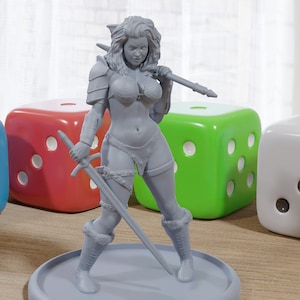 May include: A gray plastic figurine of a female warrior holding a sword and a spear. The figurine is standing on a gray base. The figurine is surrounded by four colorful dice.