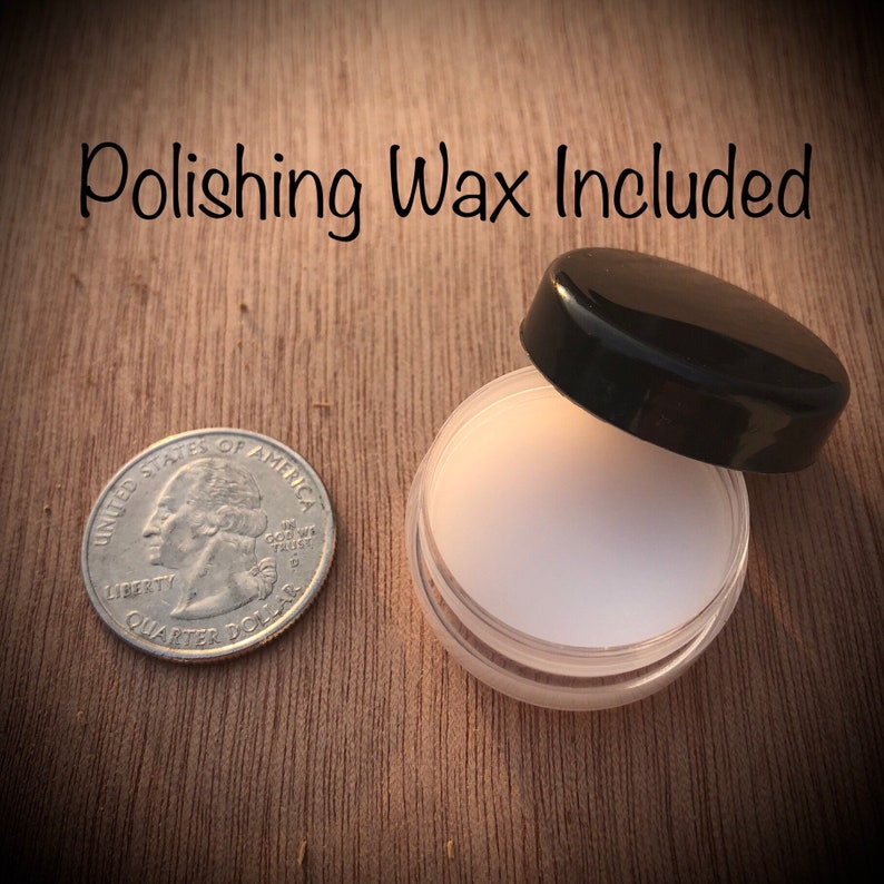 May include: A small, clear plastic jar with a black lid, containing white polishing wax. A U.S. quarter coin is next to the jar for size comparison. The text "Polishing Wax Included" is above the jar.