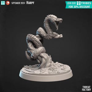 May include: A grey 3D printed miniature of a snake-like creature with a large head and open mouth, wrapped around a tree trunk. The creature is standing on a circular base with a textured surface.
