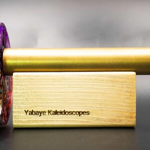 Detailed view of the vibrant colors and unique epoxy resin texture encasing the handmade brass kaleidoscope. Showcases the artistic depth and glossy finish of the body material.