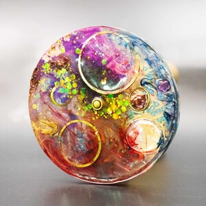 Focus on the viewing end of the brass kaleidoscope, showing the fine construction and smooth ergonomic finish. Detailed look at the connection point between the metal and the unique object chamber.