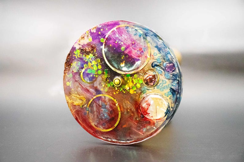 Focus on the viewing end of the brass kaleidoscope, showing the fine construction and smooth ergonomic finish. Detailed look at the connection point between the metal and the unique object chamber.