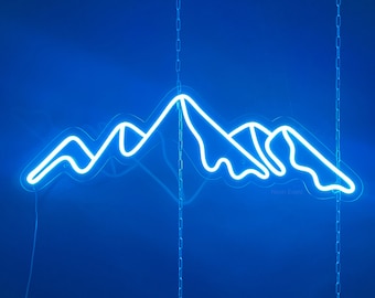May include: A neon blue mountain range sign hanging from chains against a blue background. The sign reads "Neon Events".