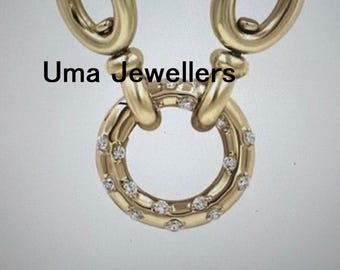 May include: A gold chain necklace featuring a circular pendant adorned with small clear stones. The pendant is attached to two thick gold links. The text Uma Jewellers is printed across the upper portion of the gold chain and pendant assembly.