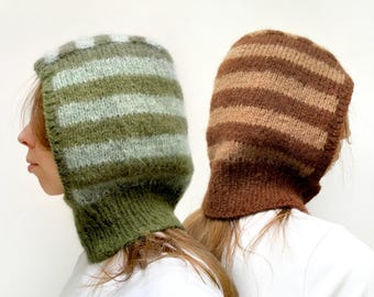 May include: Two striped knit hats, one green and white, the other brown and beige. The hats are made of a soft, fuzzy yarn and have a long, flowing design.