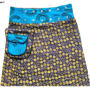 May include: A blue and yellow patterned skirt with a large pocket on the side. The skirt has a blue waistband with black and white circles.