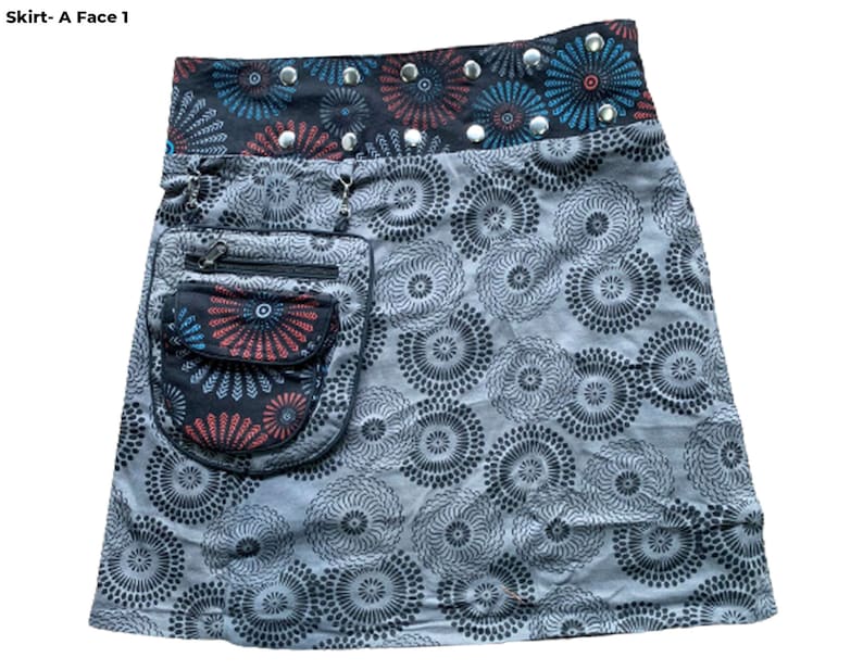 May include: A gray skirt with a black and white circular pattern. The skirt has a black waistband with a red, blue, and black patterned band and silver studs. The skirt has a large black pocket with a zipper and a smaller red, blue, and black patterned pocket.