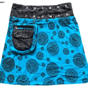 May include: A turquoise skirt with a black and gray patterned waistband and a large black pocket on the front. The skirt has a black and white mandala design.