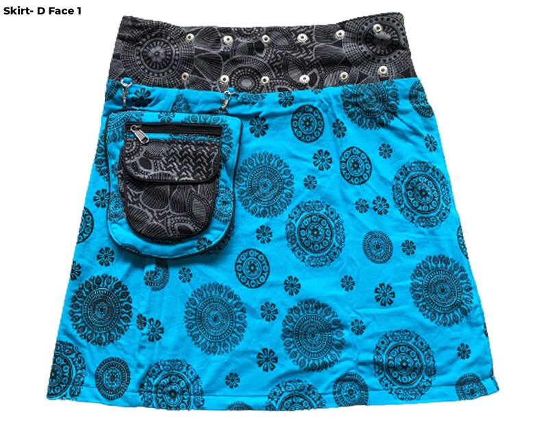 May include: A turquoise skirt with a black and gray patterned waistband and a large black pocket on the front. The skirt has a black and white mandala design.