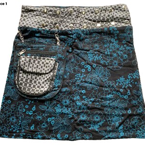 May include: A black skirt with a blue floral print and a checkered pocket. The skirt has a silver studded waistband.